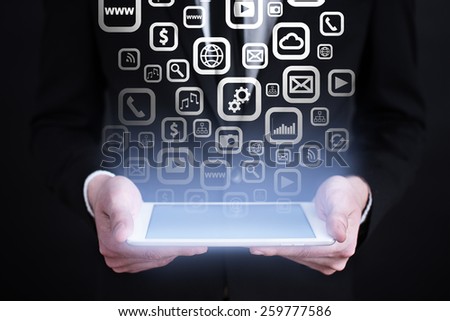 businessman holding a tablet pc with apps icons and text. Internet concept. business concept. 