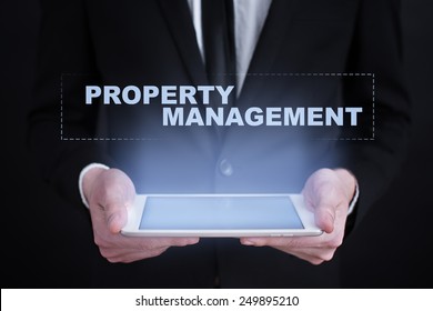 Businessman Holding A Tablet With Property Management Concept.