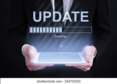 Businessman Holding A Tablet With Update Loading Bar  On The Screen. Internet Concept. Business Concept.