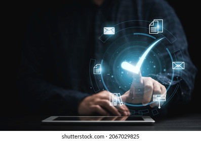 Businessman holding tablet with virtual document and mark correct sign for online approve  paperless and quality assurance concept. - Shutterstock ID 2067029825