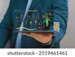 Businessman holding tablet with virtual farming map screen global strategy planning. Planning growth for success Farming innovation. Digital Application control smart farming organic. AI technology.