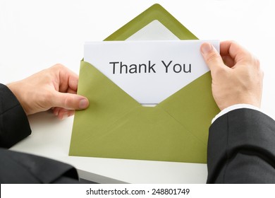 Businessman Holding Thank You Card In Green Envelope