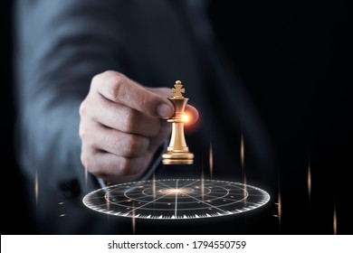 Businessman holding and throwing golden king chess to virtual target dart board. Setup objectives and target for business investment concept.