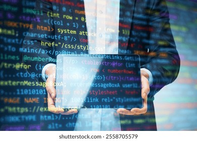 Businessman holding transparent tablet with colorful programming code overlay, modern digital background, concept of coding and tech innovation - Powered by Shutterstock