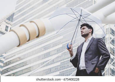 Businessman holding umbrella in city outdoor