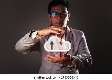 A Businessman holding virtual cloud computing on hand with a connection line. Cloud computing is a system for sharing download and upload big data information, business, and technology concept.