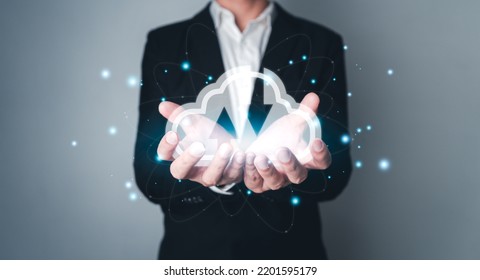Businessman holding virtual cloud computing on hand with connection line.Cloud technology. Data storage. Networking and internet service concept. - Shutterstock ID 2201595179