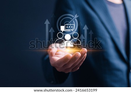 Businessman holding virtual target customer icon for customer focus group and Targeting customer concept. Digital marketing online, CRM, Data exchanges development and customer service.