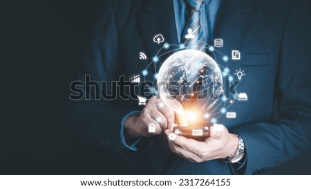 Businessman holding virtual world with icons and connection line for data exchange from globalization innovation technology and global business concept.