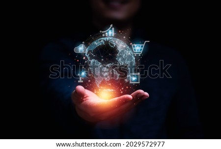 Businessman holding virtual world and technology icons communication working and transaction ,Global  business by internet connection technology for financial banking , big data and digital linkage.