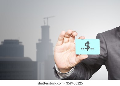 Businessman Holding Visit Card In Hand And Standing With Building, Business Idea Concept