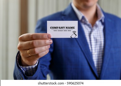 Businessman Holding Visit Card. Man Showing Blank Business Card With Phone Icon. Person In Blue Suit. Mock Up Design.