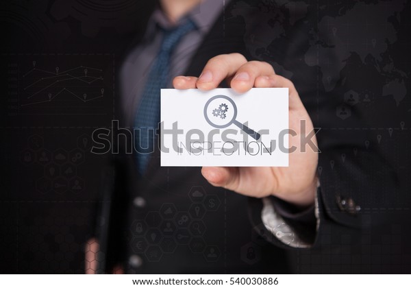 Businessman Holding White\
Visit Card With Icon And Text Inspection, Touch Screen. Virtual\
Icon. Graphs Interface. Business concept. Internet concept. Digital\
Interfaces