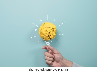 Businessman Holding Yellow Scrap Paper Ball With Illustration Painting For Virtual Lightbulb. It Is Creative Thinking Idea And Innovation Concept.