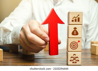 Businessman holds an up arrow near business attributes. Expansion of business company. Using new approaches and tools. Development of leadership organizational skills. Entrepreneurship management.