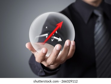 Businessman Holds Crystal Ball With Rising Red Graph And Broken White Graph