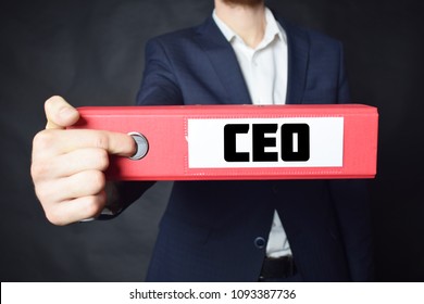 A businessman holds a folder with the inscription:CEO - Shutterstock ID 1093387736