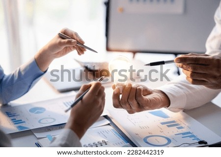 Businessman holds a glowing lamp, Creative new idea. Innovation, brainstorming, strategizing to make the business grow and be profitable. Concept execution, strategy planning and profit management.