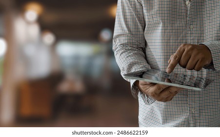 businessman holds a mockup. iPad digital tablet in office multitasking searching the internet - Powered by Shutterstock