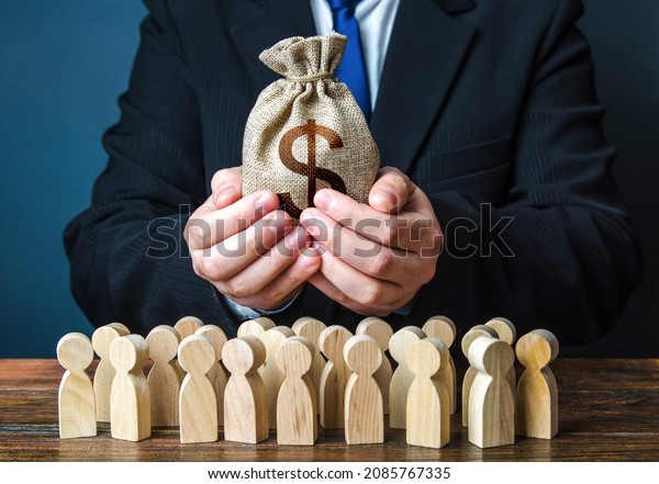 Businessman holds out a dollar money bag to the\
crowd. Official. Providing money, paying salaries and grants. Staff\
maintenance. Financial support. Tax collection. Compensation\
payments. Share\
profit.