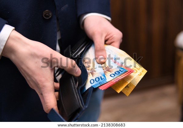 businessman\
holds Swiss francs in various denominations. Placing your savings\
in Swiss francs as a safe and stable\
currency