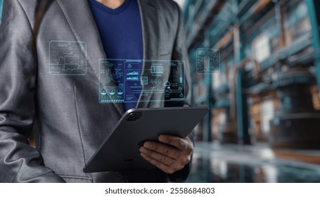 A businessman holds a tablet displaying augmented reality data visualization. The modern workspace highlights technology's role in business and analytics. - Powered by Shutterstock