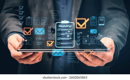 Businessman holds a tablet displaying holographic checklists, emails, and document icons. Abstract digital interface representing data management
