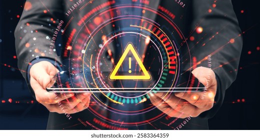 Businessman holds tablet with glowing warning icon, futuristic digital interface, and binary code background, representing cybersecurity risk concept
