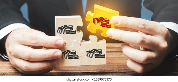 Businessman holds the wooden puzzle with a picture of money. The concept of financial management and distribution of funds. Saving and investing. Property division. Divorce and legal services