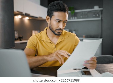 Businessman, home office and documents by laptop in kitchen for focus, small business growth and opportunity. Digital entrepreneur, business owner and reading with contract, proposal and paperwork - Shutterstock ID 2266911989