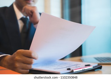 Businessman or HR Manager is reviewing Resume information on his wooden desk. Employment and recruitment concept
 - Powered by Shutterstock