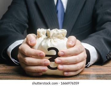 Businessman hugs ukraine hryvnia money bags. Budget, tax collection. Granting financing business project. Trade, economics. Growth of corruption kickbacks, appropriation of funds. Provision loan. - Shutterstock ID 1666976359