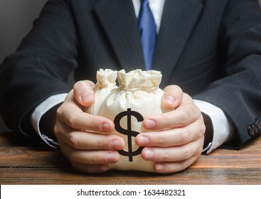 Businessman hugs US dollar money bags. Bank deposit. Budget management, tax collection. Trade, economics. Granting financing business project or education. Provision financial loan credit. Corruption
