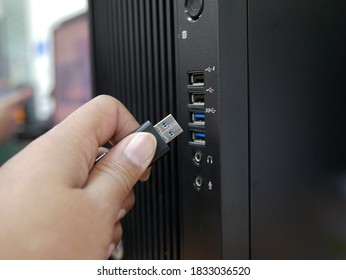 Businessman Inserting USB Thumb Drive To Computer.