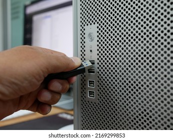 Businessman Inserting USB Thumb Drive To Computer.	