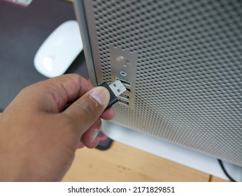 Businessman Inserting USB Thumb Drive To Computer.