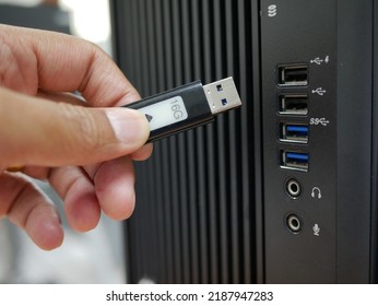 Businessman Inserting USB Thumb Drive To Computer.	