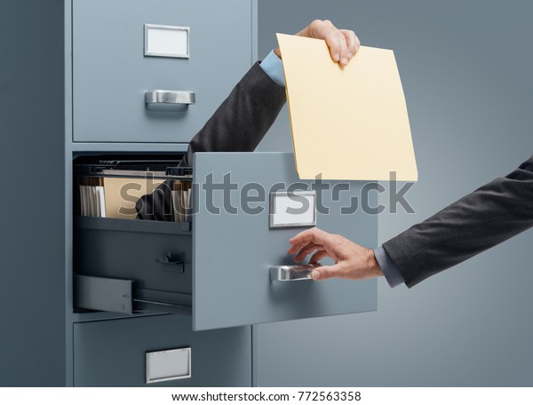 Businessman Inside Filing Cabinet Giving File Stock Photo Edit