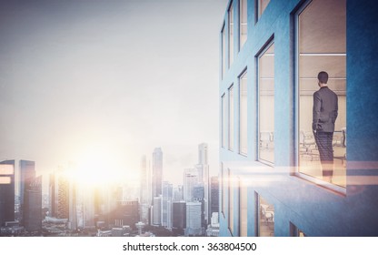 Businessman Inside Skyscraper, Lookng At The City Through  Window. Horizontal