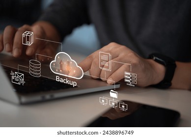 Businessman Interacting with a Backup Interface virtual cloud network data security system internet online with futuristic holographic digital technology. - Powered by Shutterstock