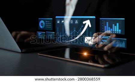 Businessman Interacting with Digital Analytics Dashboard on Laptop with Graphs and Charts for Data-Driven Decision Making in Modern Workspace