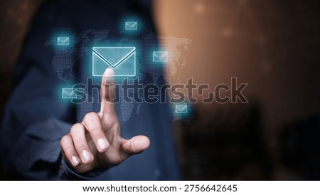 Businessman interacting with digital email interface on virtual screen with global network background. Concept of email marketing, communication technology, data exchange and business connectivity.