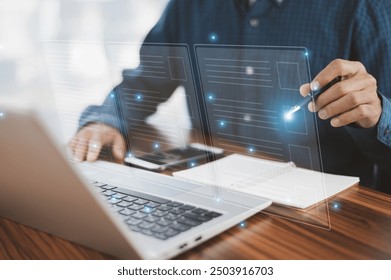 Businessman interacting with a futuristic digital interface, using a stylus to select and manipulate data on a transparent screen while working on a laptop, symbolizing advanced technology - Powered by Shutterstock