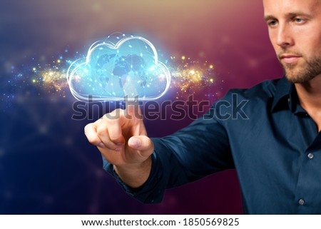 businessman interacting with a virtual cloud in front of blue background