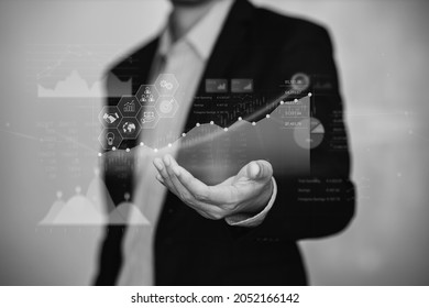 Businessman interaction with artificial intelligence to invest bitcoin price digital chart exchange. Concept of cryptocurrency and nft of blockchain technology on stock market. Black and white tone.