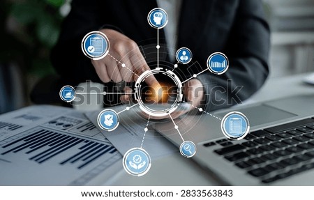 A businessman interacts with a digital interface showcasing data analysis, visualizations, and technology in a modern office environment, reflecting innovation. Crux