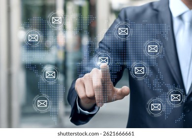 A businessman interacts with a digital world map illustrating global communication through email icons. The setting reflects a modern tech driven environment that enhances connectivity.