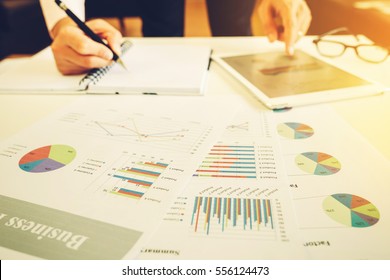 Businessman Investment Consultant Analyzing Company Annual Financial Report Balance Statement Working With Documents Graphics. Concept Picture Of Economy, Market, Office,money And Tax.