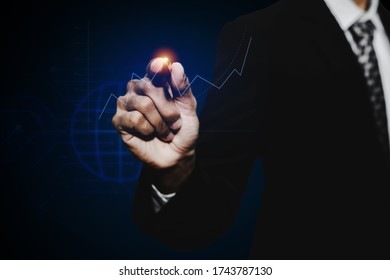 businessman investor hand pointing with pen on virtual graphic graph chart screen on dark background, stock market, investment, digital technology, trading statistics and business strategy concept - Powered by Shutterstock - Get 15% off with code: PIKWIZARD15
