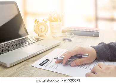 Businessman Or Job Seeker Review His Resume On His Desk Before Send To Finding A New Job With Computer Laptop.